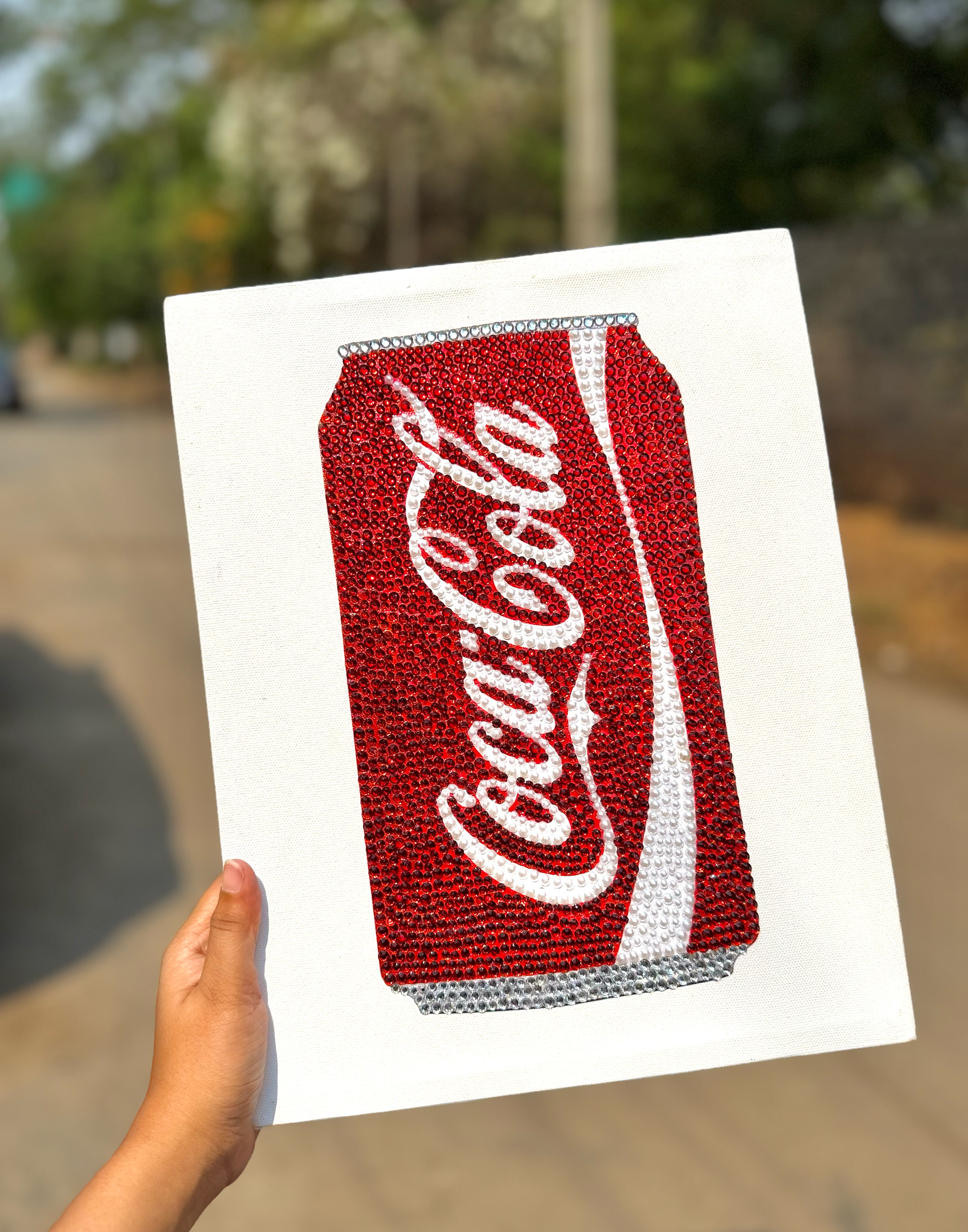 Coca-Cola can design bedazzled on a white canvas